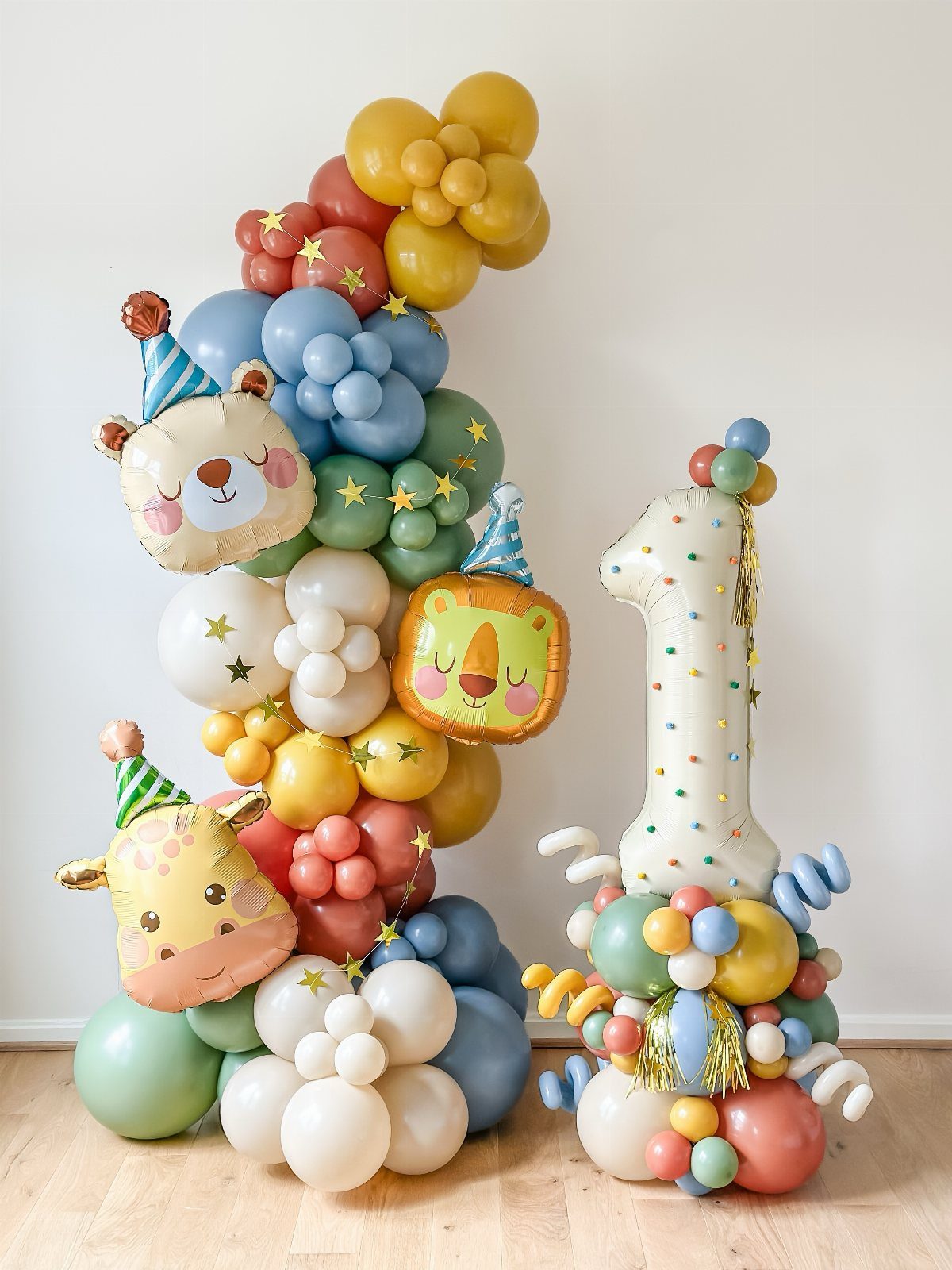 Colorful balloon garland with animal foil balloons and a large number one balloon.