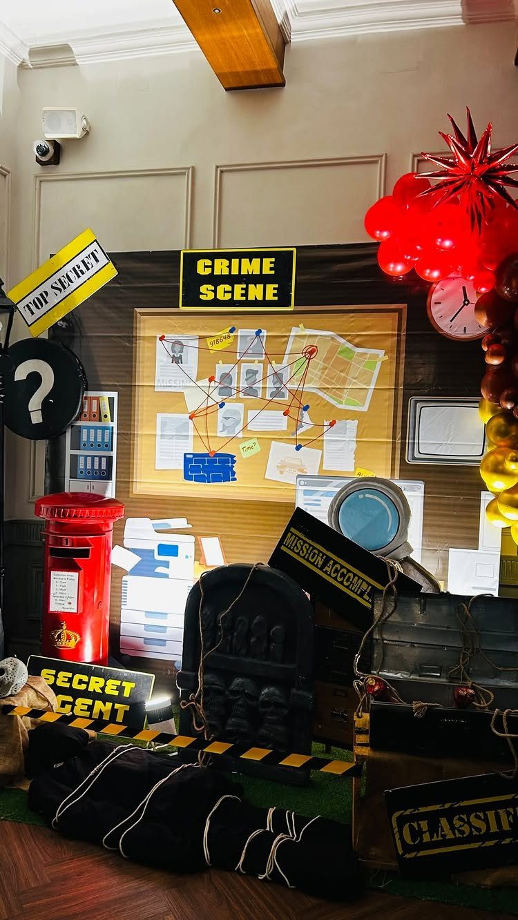 Detective themed party setup with a crime scene board and secret agent props.