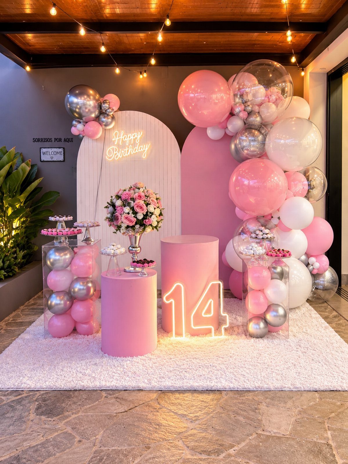 Pink and silver birthday party decorations with a glowing neon 14 sign