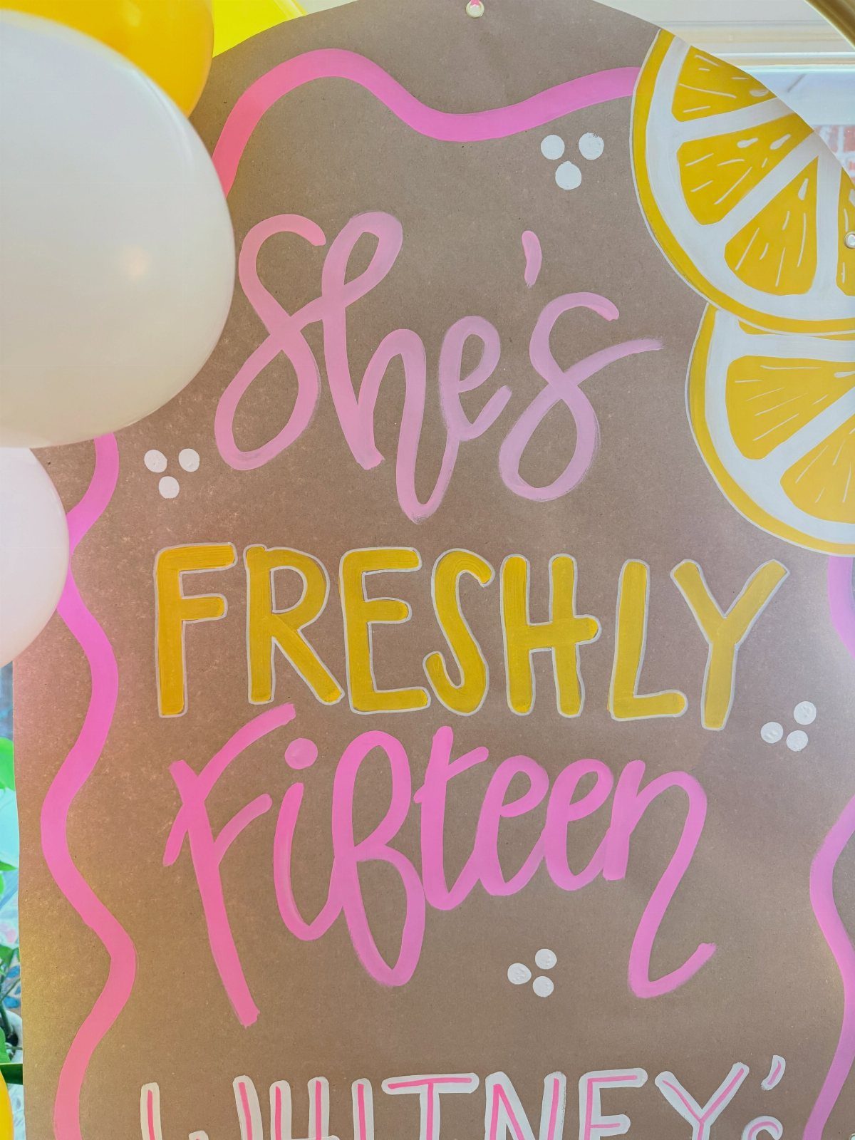 Brown party sign with pink and yellow lettering celebrating a fifteenth birthday