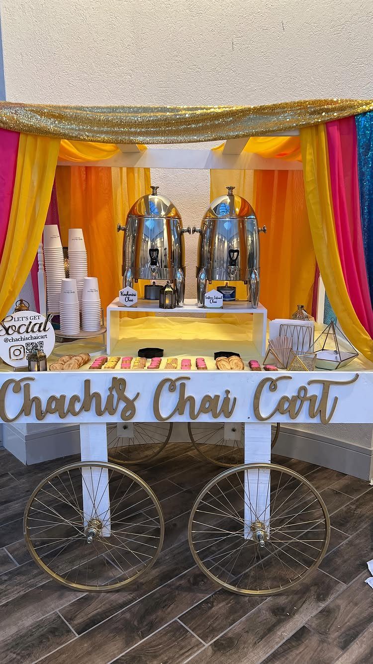 Chachi's Chai Cart with silver dispensers and colorful fabric decorations for a party.