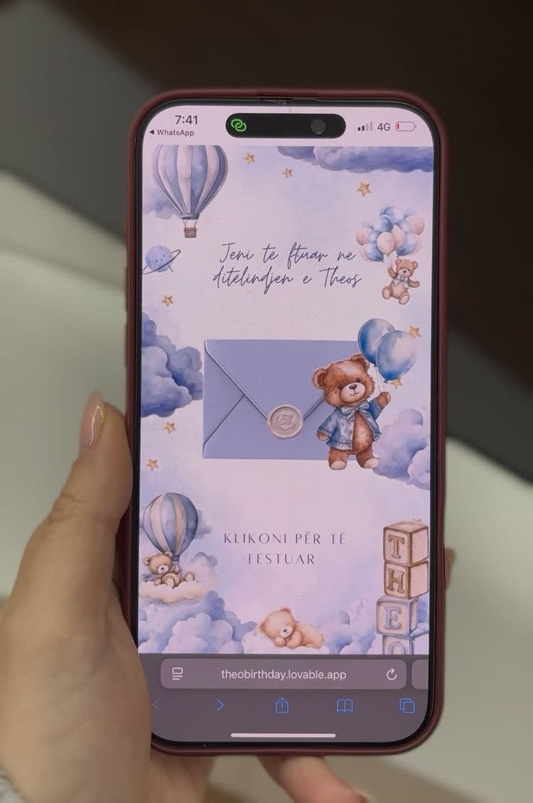 Smartphone screen displaying a digital birthday invitation with teddy bears and hot air balloons.