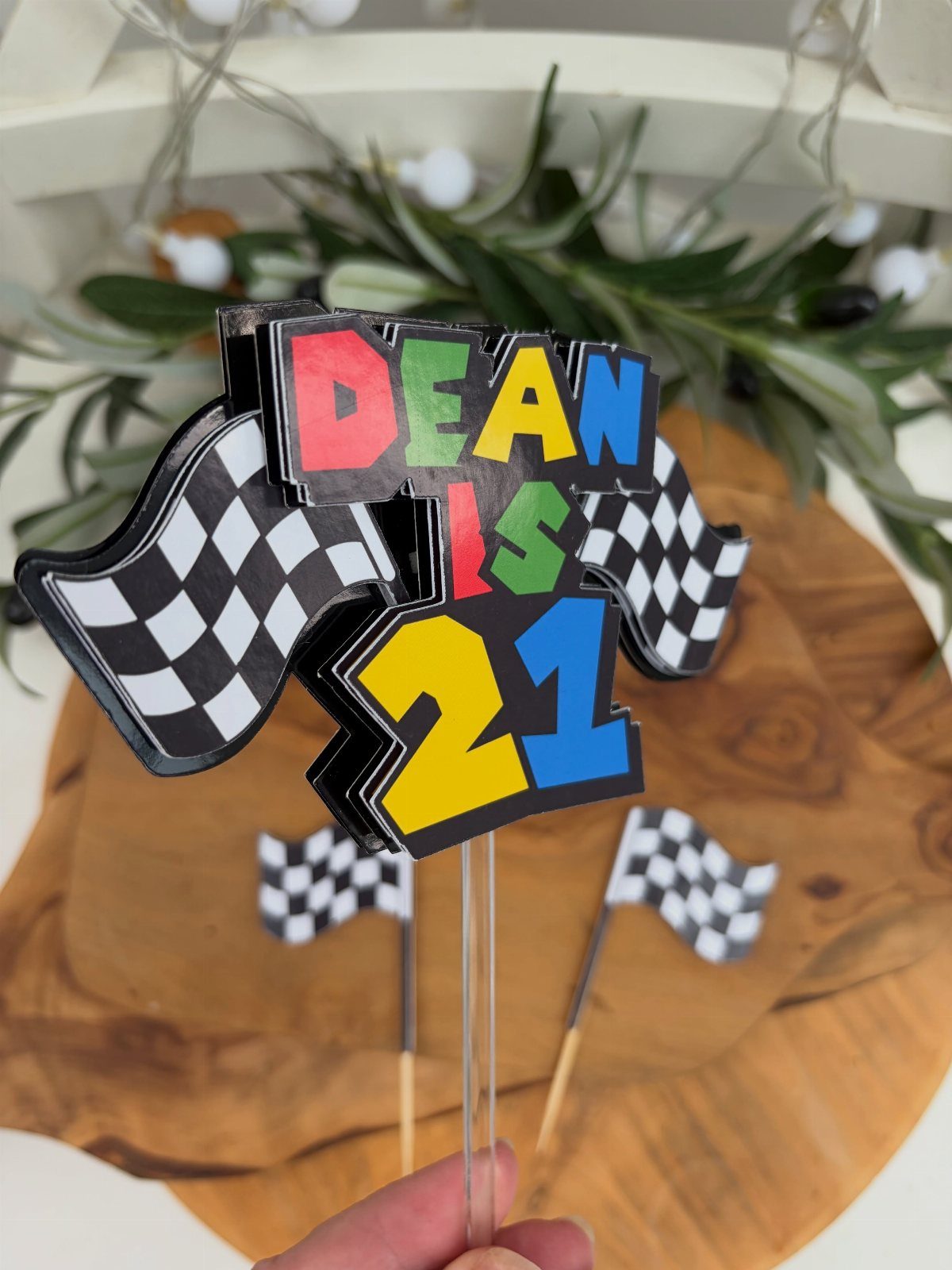Racing themed 21st birthday cake topper with checkered flags and colorful text