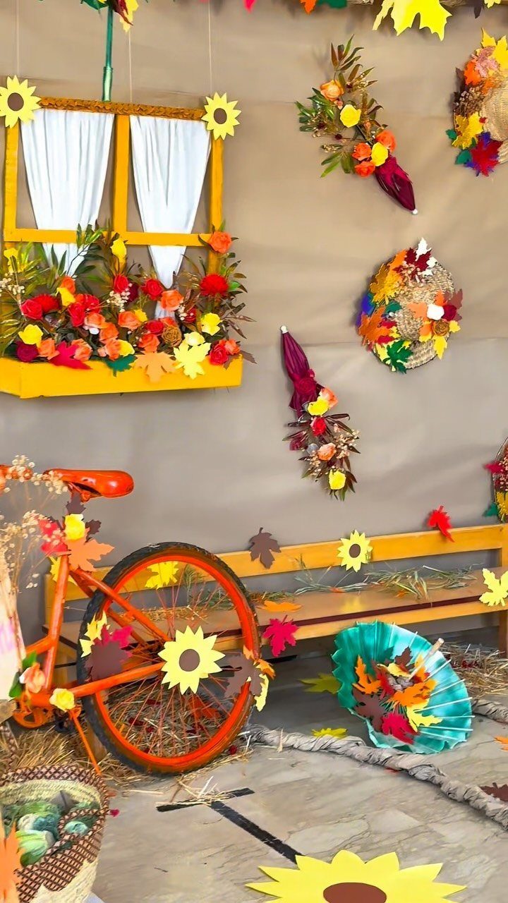Autumn decorative backdrop with an orange bicycle, yellow window, and fall foliage.