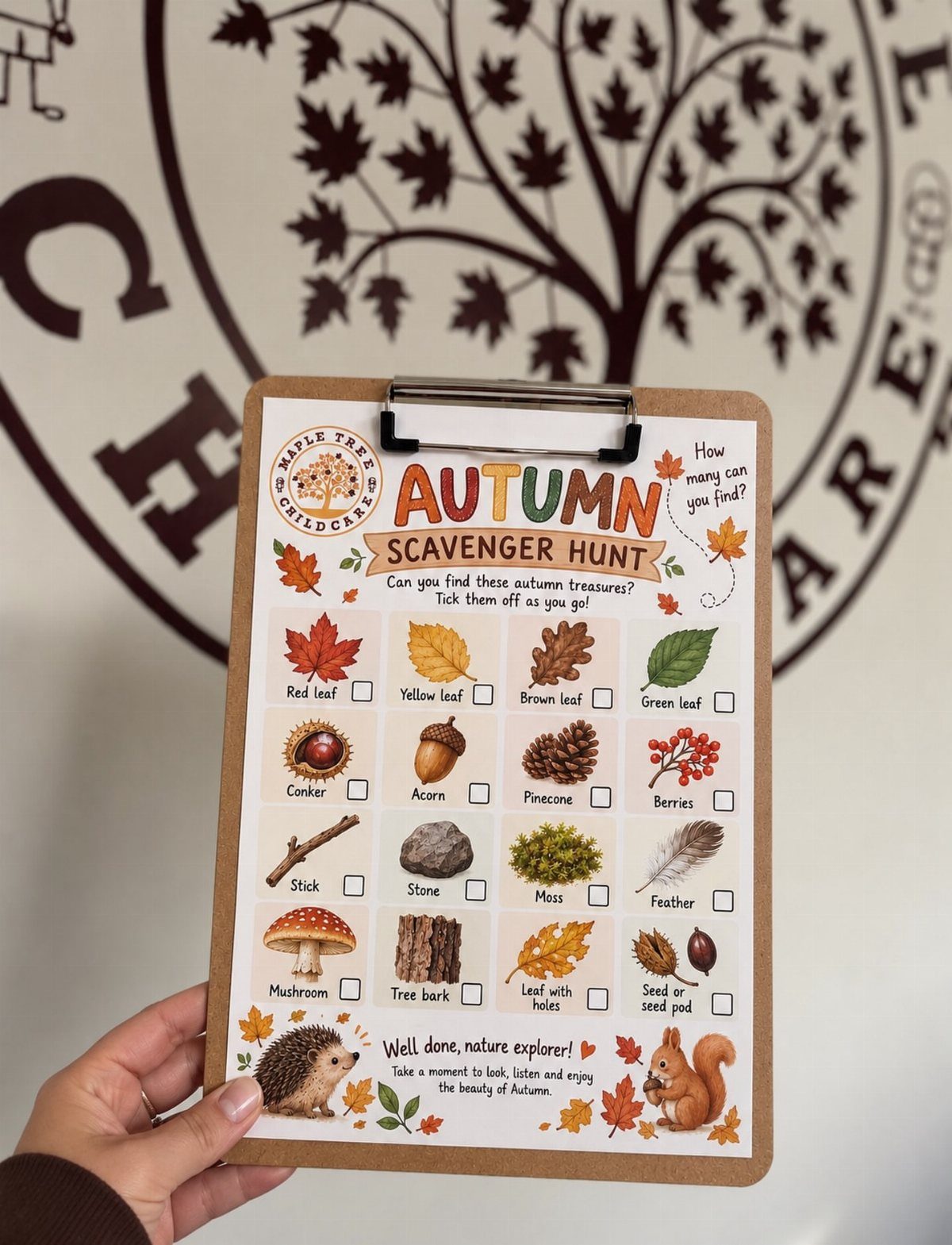 Autumn scavenger hunt checklist on a clipboard held by a hand against a wall.