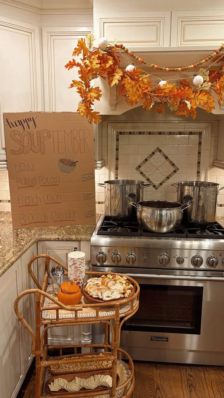 Soup party setup with large pots on a stove and autumn decorations.