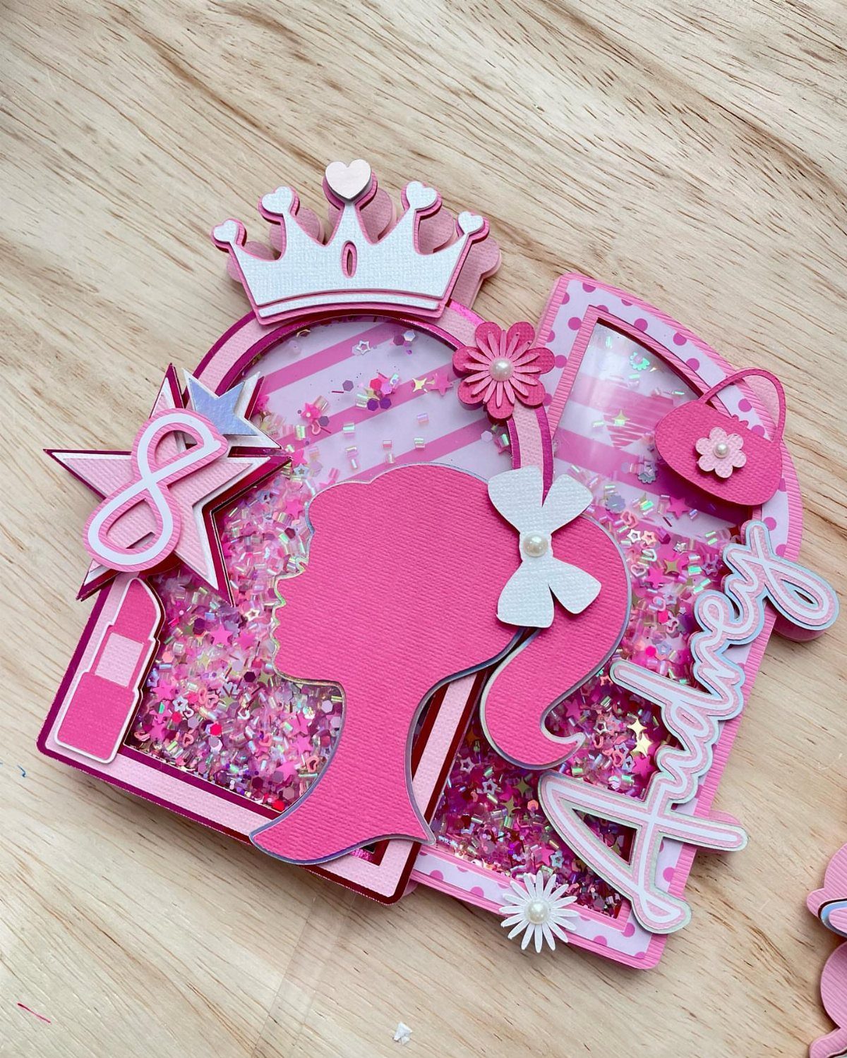 Pink Barbie silhouette cutout with glitter, a crown, and the name Audrey.