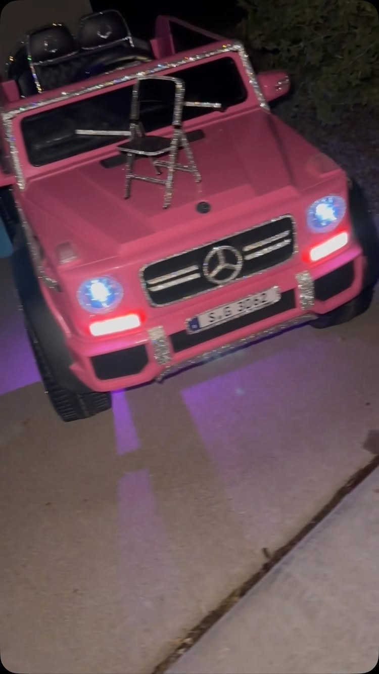 Pink toy Mercedes G-Wagon with rhinestone accents and a small sparkling chair