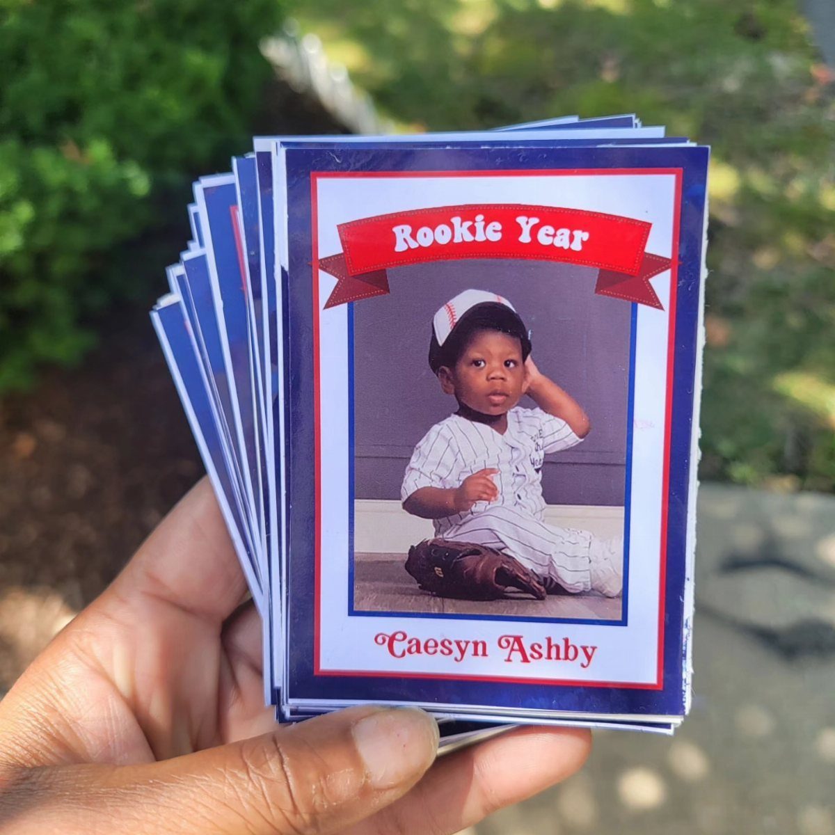 Baseball card invitations featuring a young child in a baseball uniform and gear.