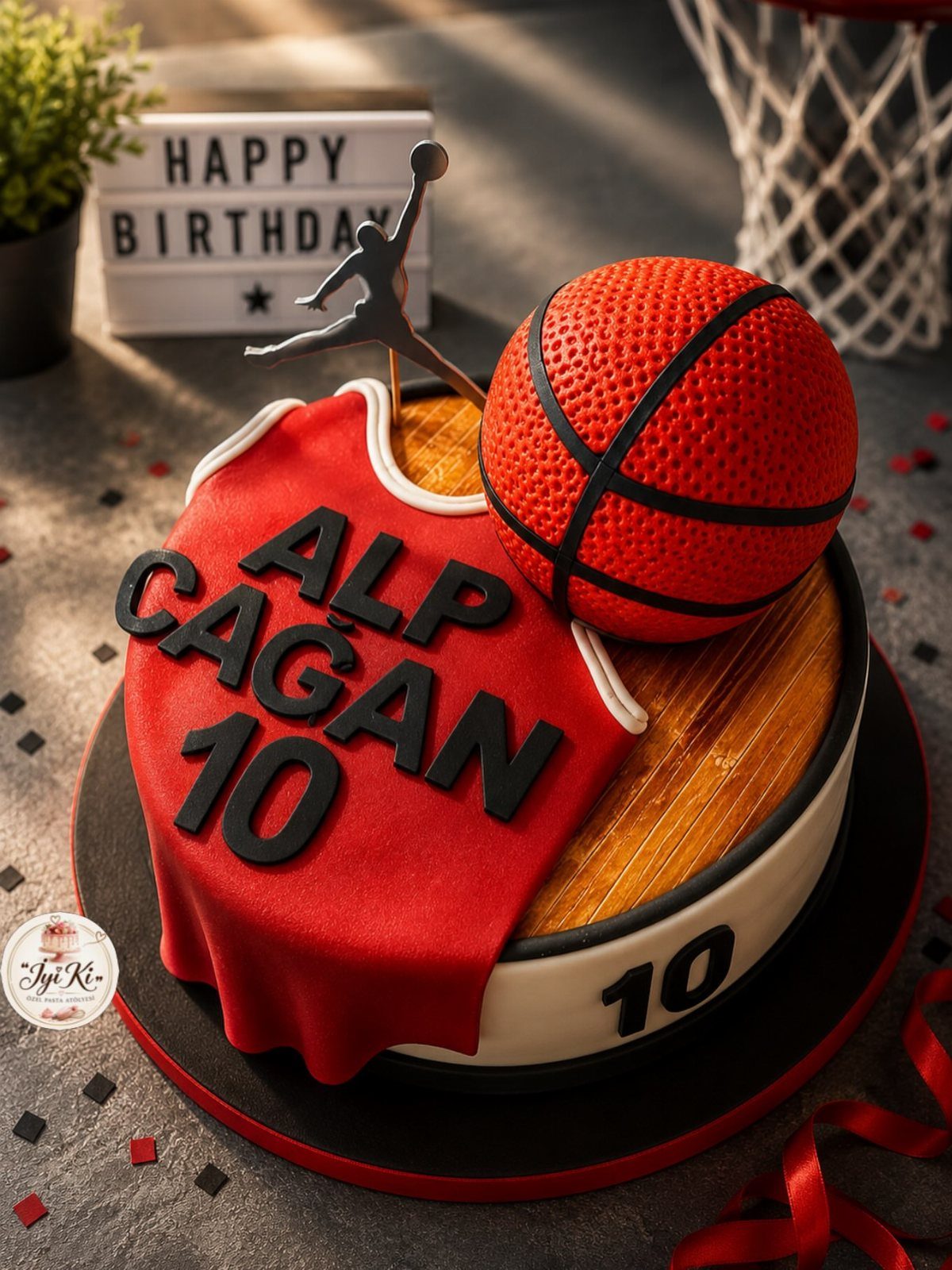 Basketball cake featuring a red jersey drape, an orange basketball, and court-themed icing.
