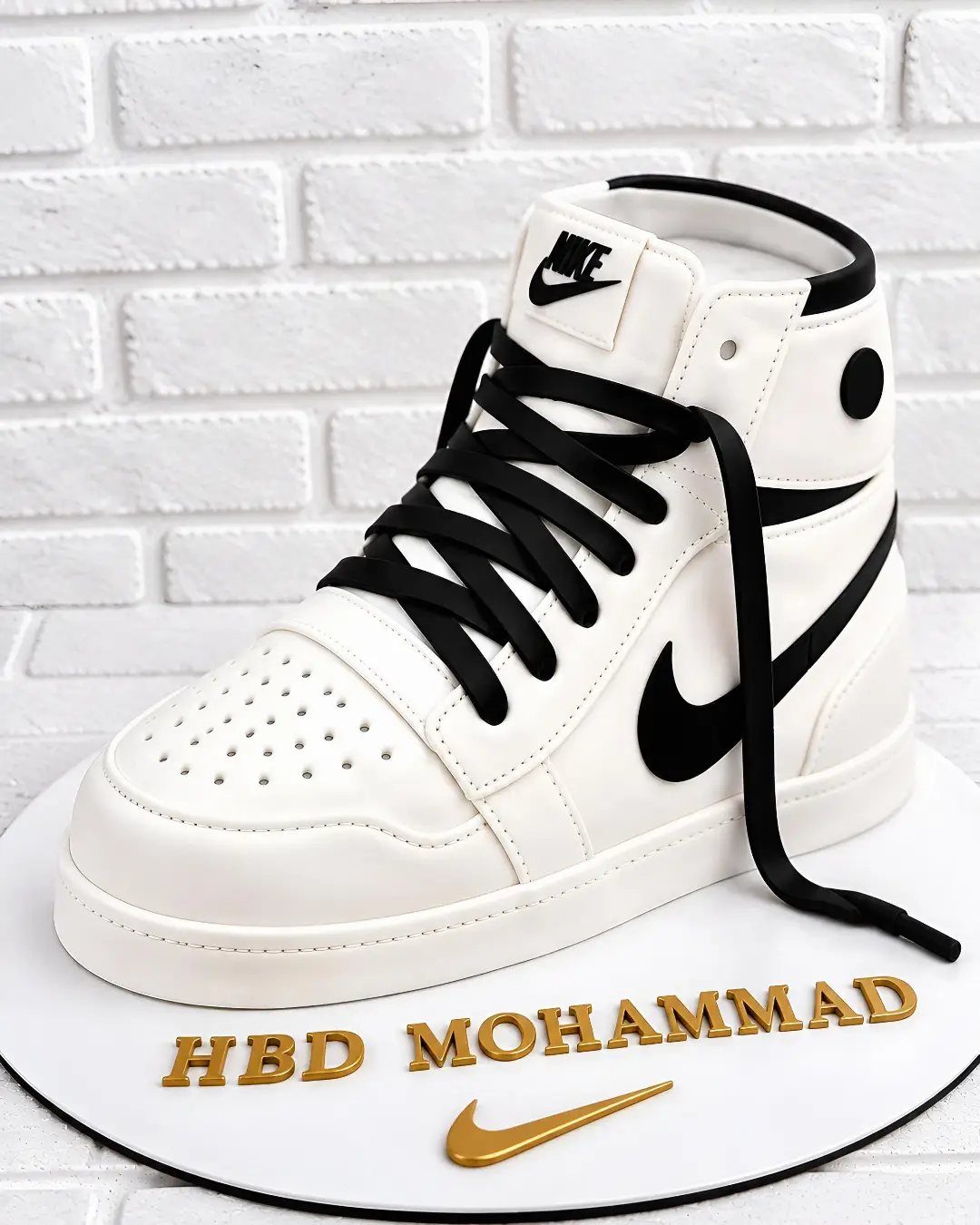 Basketball shoe cake shaped like a white Nike sneaker with black laces and swoosh.