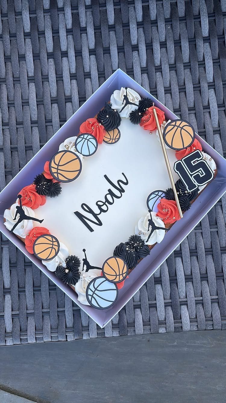 White sheet cake decorated with basketball toppers, red and black frosting, and name Noah.