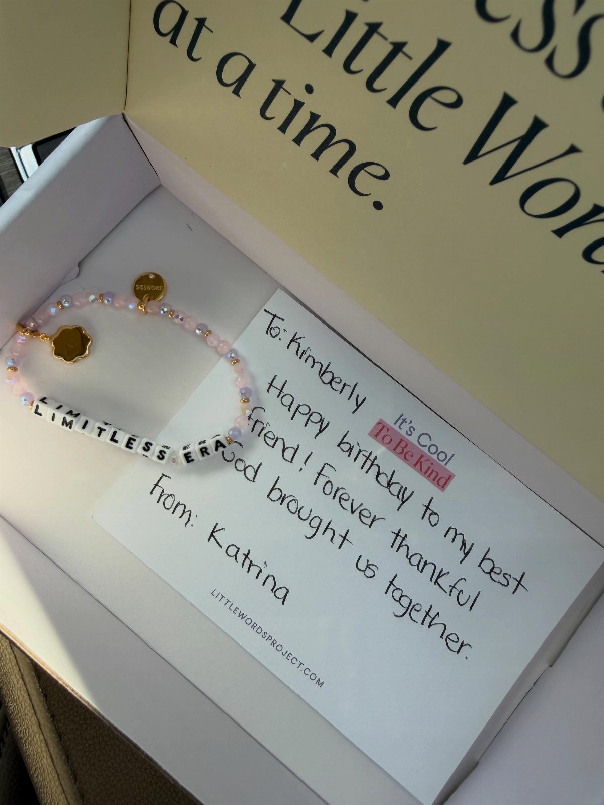 Beaded friendship bracelet with 'LIMITLESS ERA' text and a handwritten birthday note.