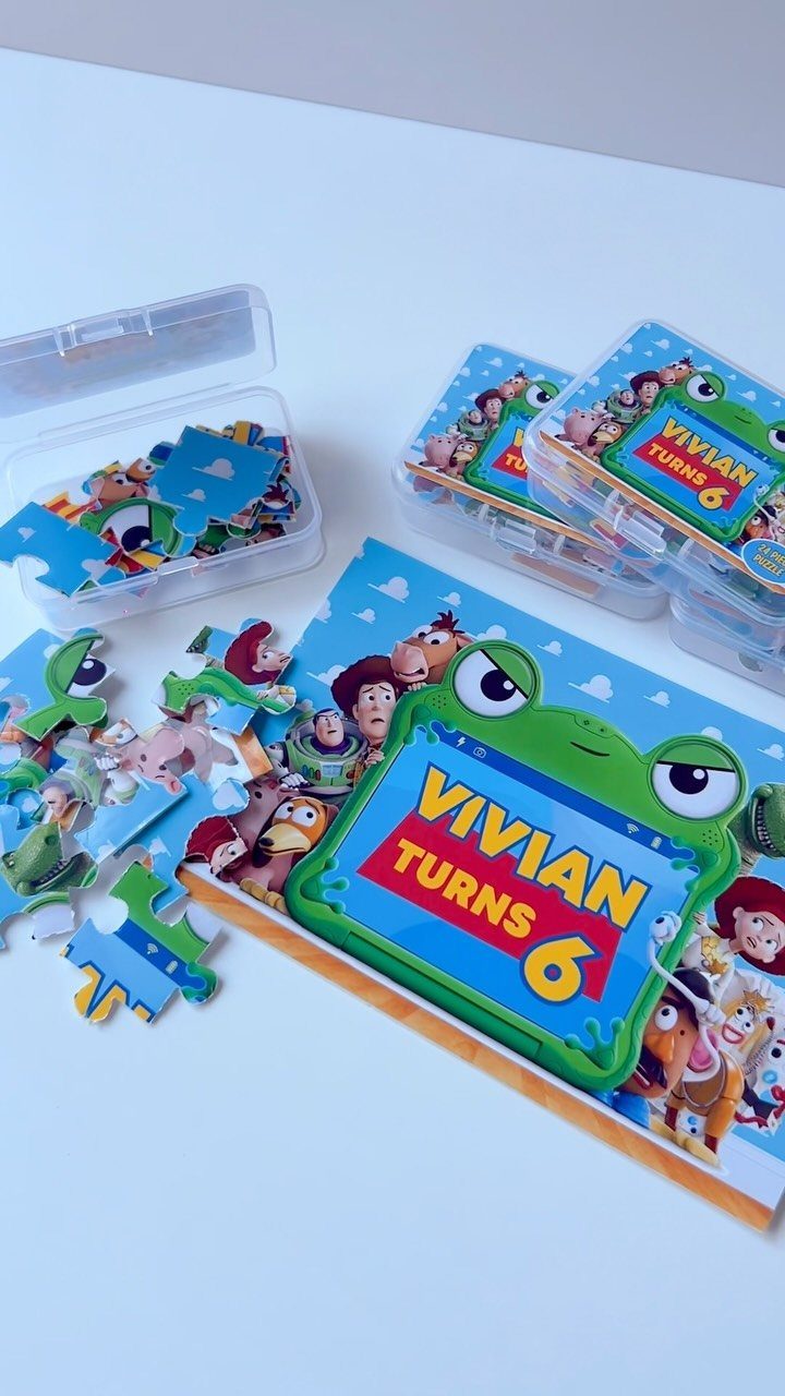 Toy Story themed custom jigsaw puzzles in clear boxes for a sixth birthday party.