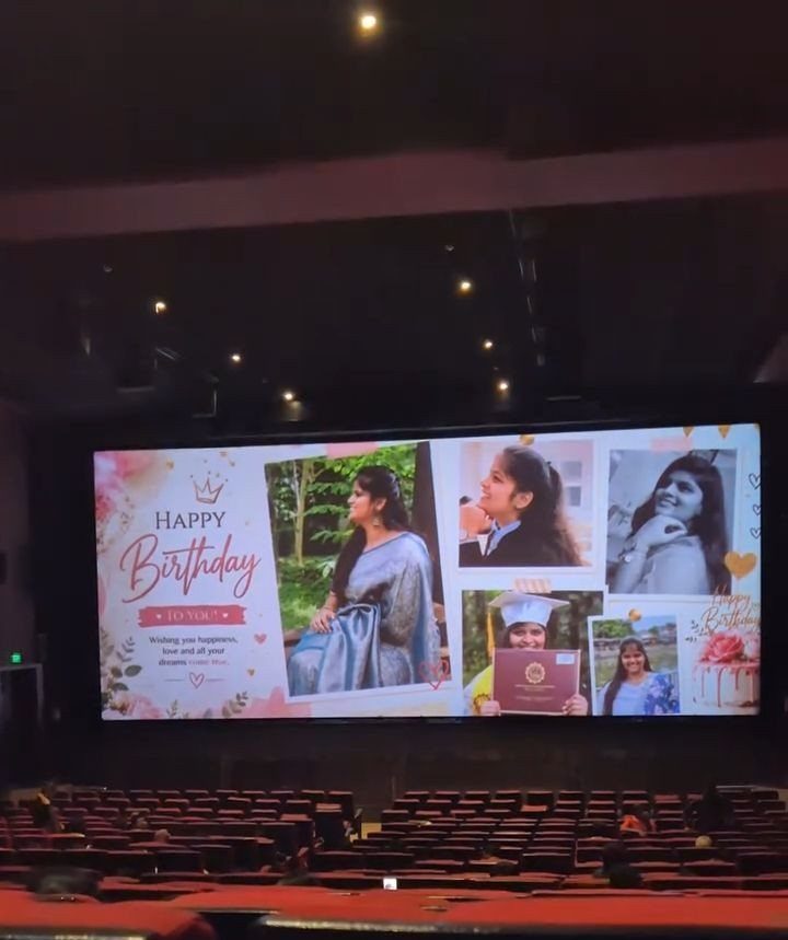 Movie theater screen showing a birthday photo collage above rows of red seats.