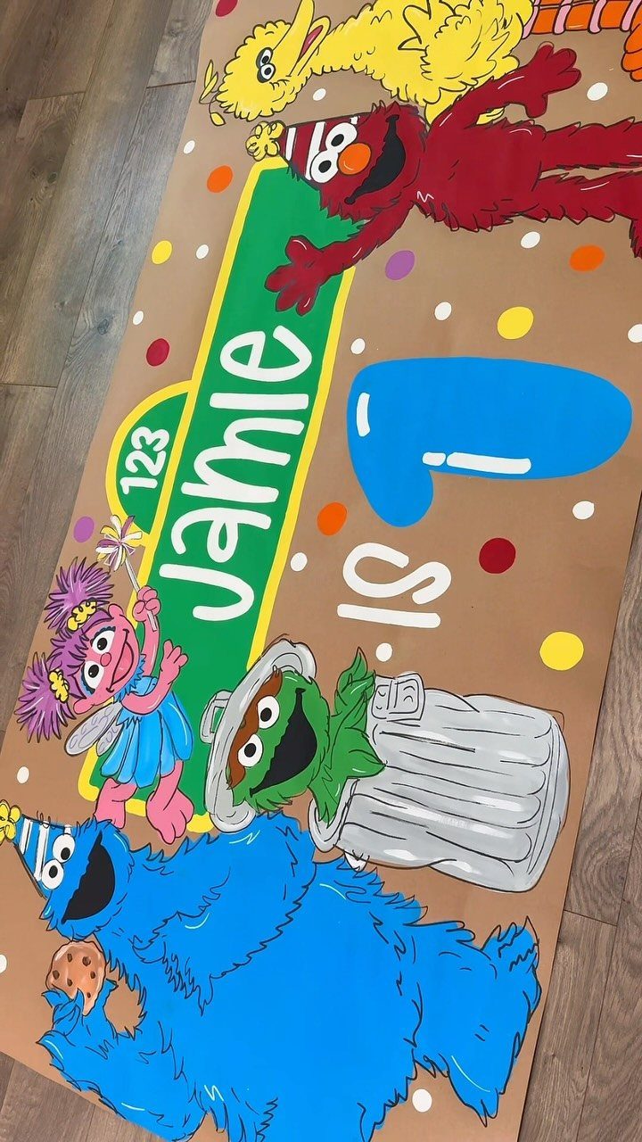 Sesame Street themed birthday banner for Jamle's first birthday with colorful characters.