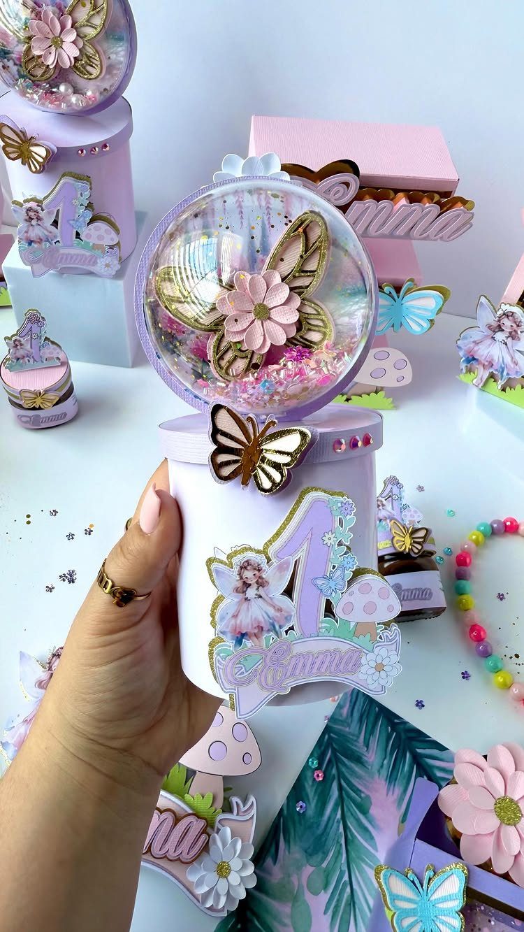 Fairy themed party favor container with a butterfly globe and fairy illustration.
