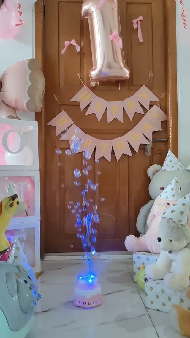 Bubble machine creating bubbles in a room decorated for a first birthday party.