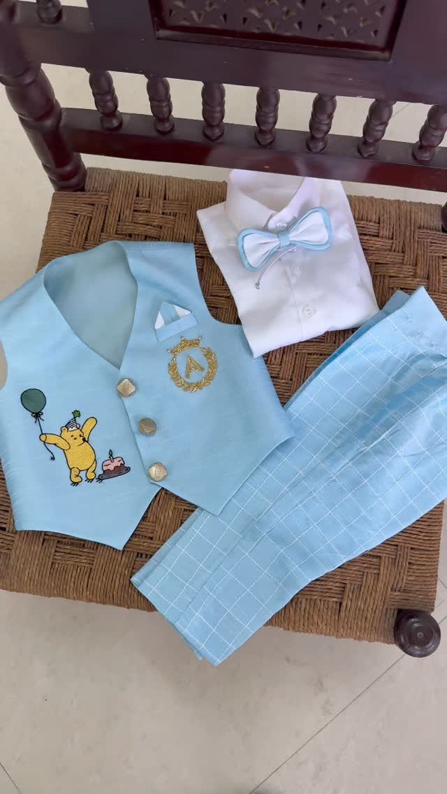 Light blue baby boy's three-piece birthday outfit with Winnie the Pooh embroidery.