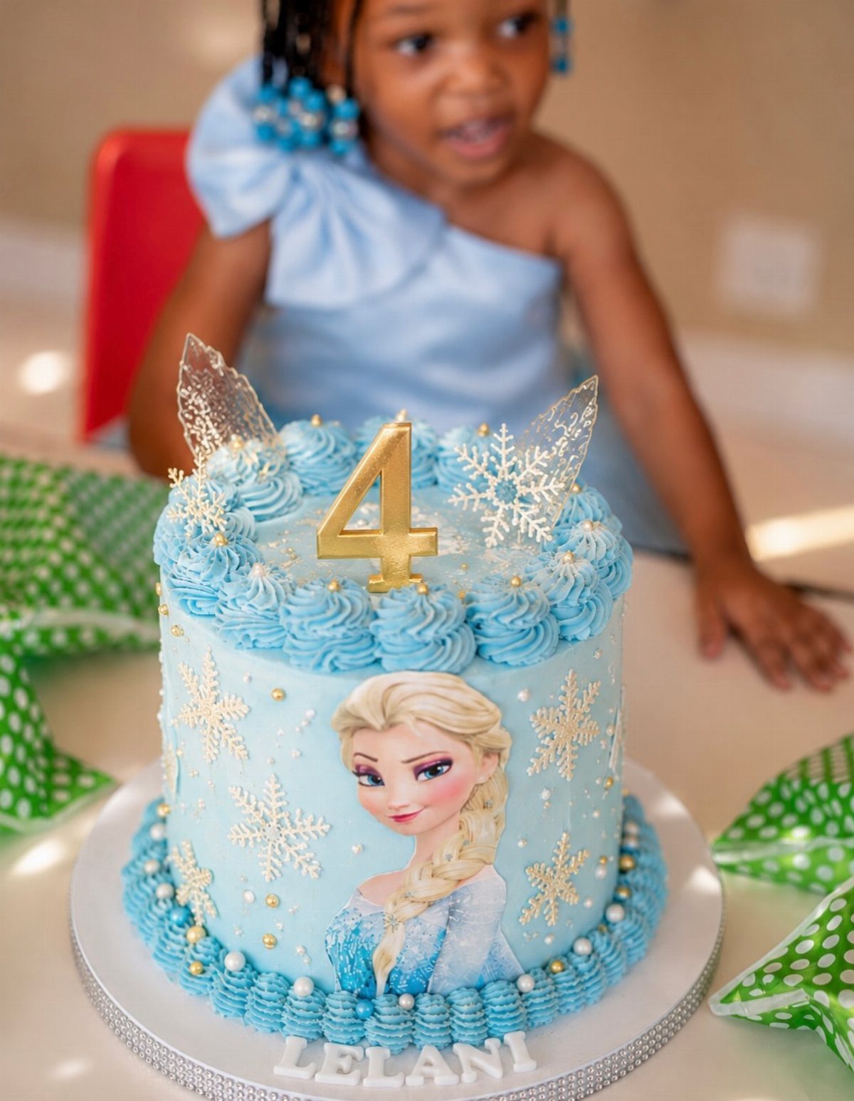 Blue Frozen themed birthday cake with Elsa image and gold number 4 topper