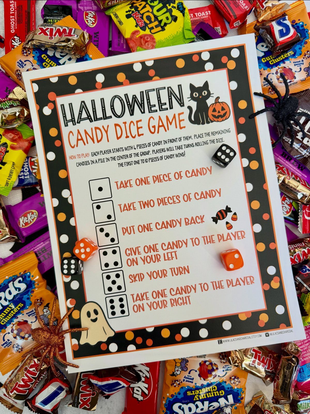 Halloween Candy Dice Game instruction sheet surrounded by colorful candies and gaming dice.