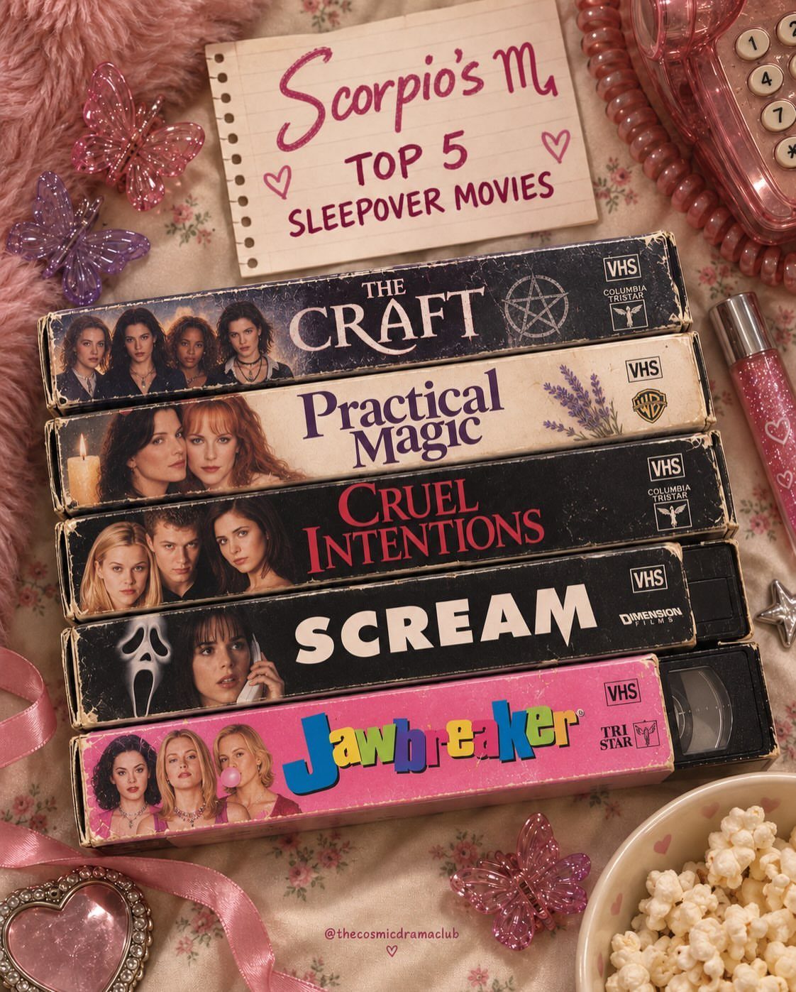 VHS tapes of sleepover movies with popcorn and pink accessories on floral fabric