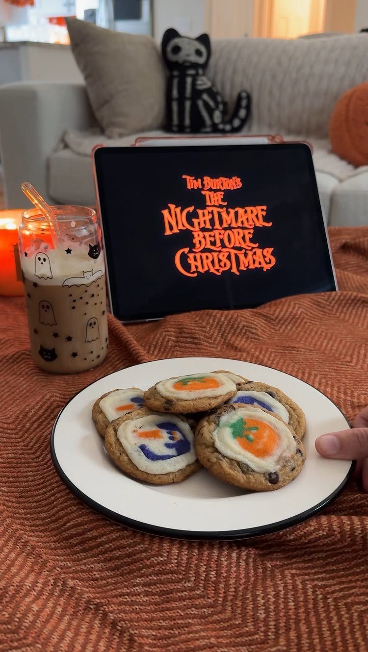 Decorated cookies and a themed drink next to a tablet playing a movie.