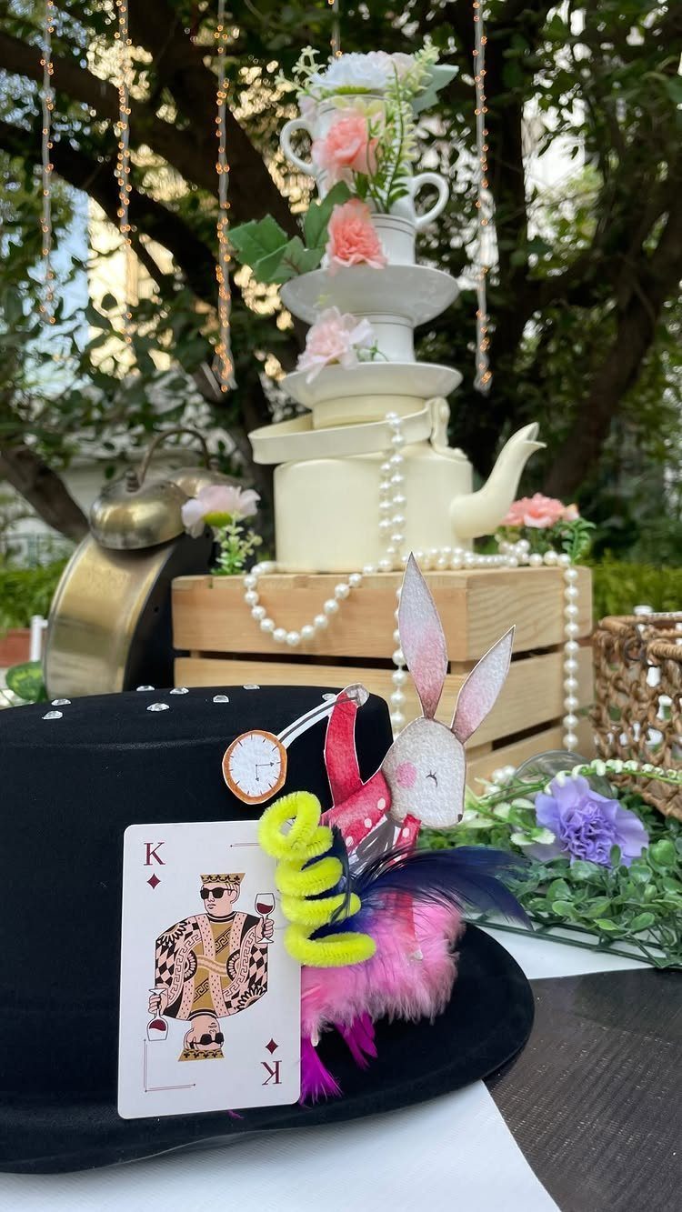 Whimsical Alice in Wonderland themed party decorations with a top hat and teacups.
