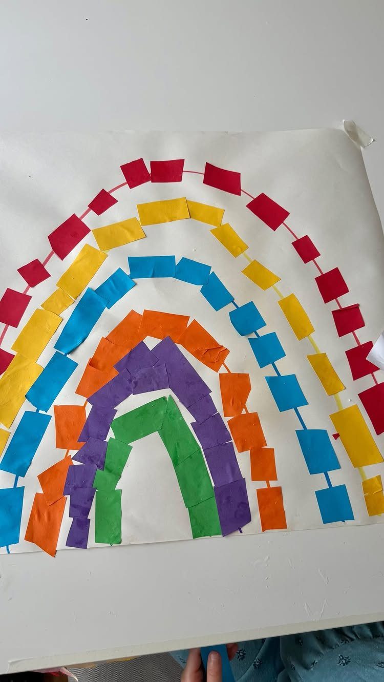Rainbow artwork made from colorful paper squares glued onto a white page.