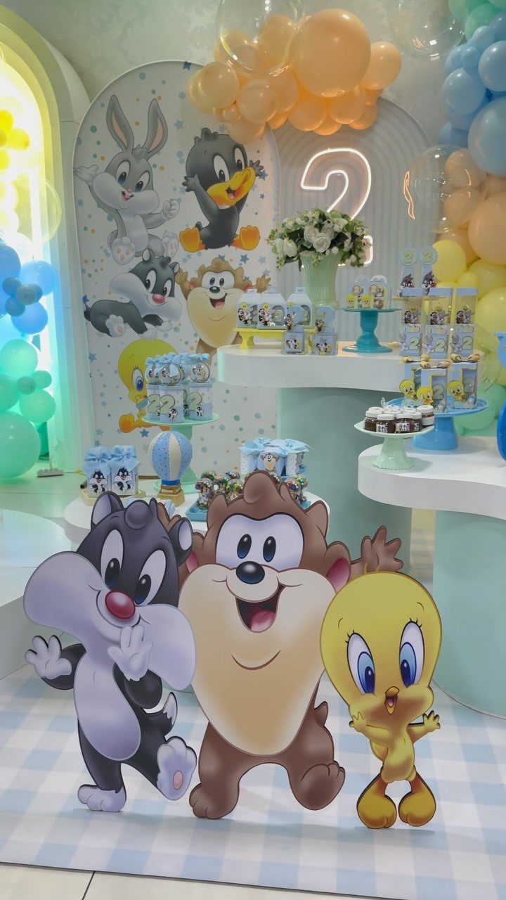 Baby Looney Tunes themed second birthday party decorations with character cutouts and balloons