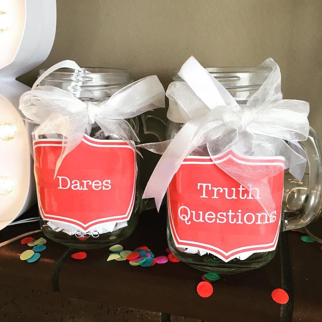 Two mason jars labeled Truth Questions and Dares filled with white paper slips.