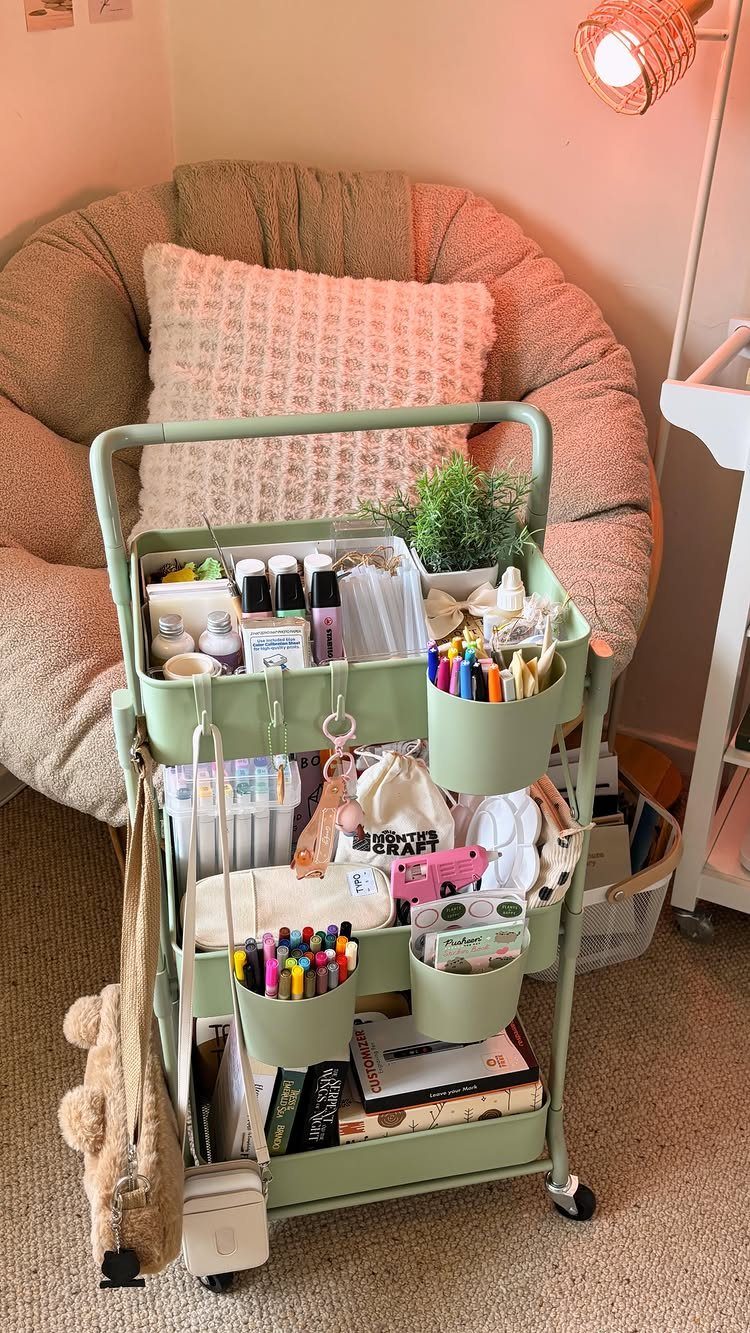 Mint green rolling cart filled with colorful art supplies next to a bean bag.