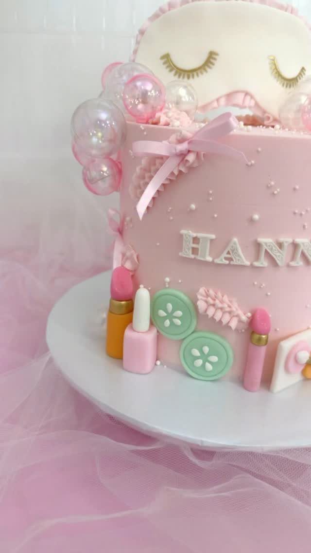 Pink spa themed cake decorated with edible makeup, bubbles, and sleeping eyes topper.