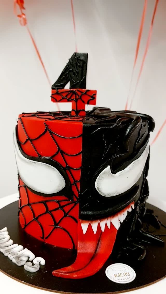 Split cake featuring Spider-Man's red webbed face and Venom's black face with tongue.