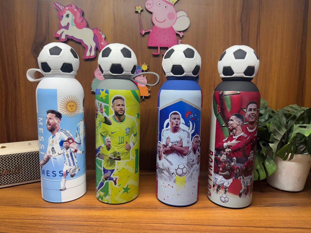 Four customized water bottles with soccer player graphics and soccer ball caps.