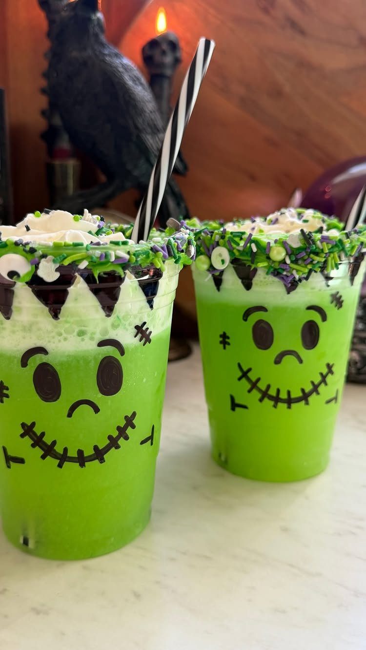 Green monster-themed drinks with foam and sprinkles on a white surface