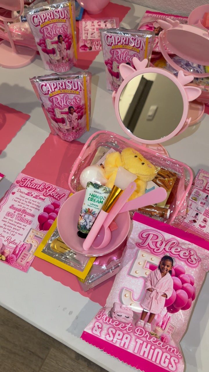 Pink party favors including spa supplies, drinks, and a mirror for a sleepover.