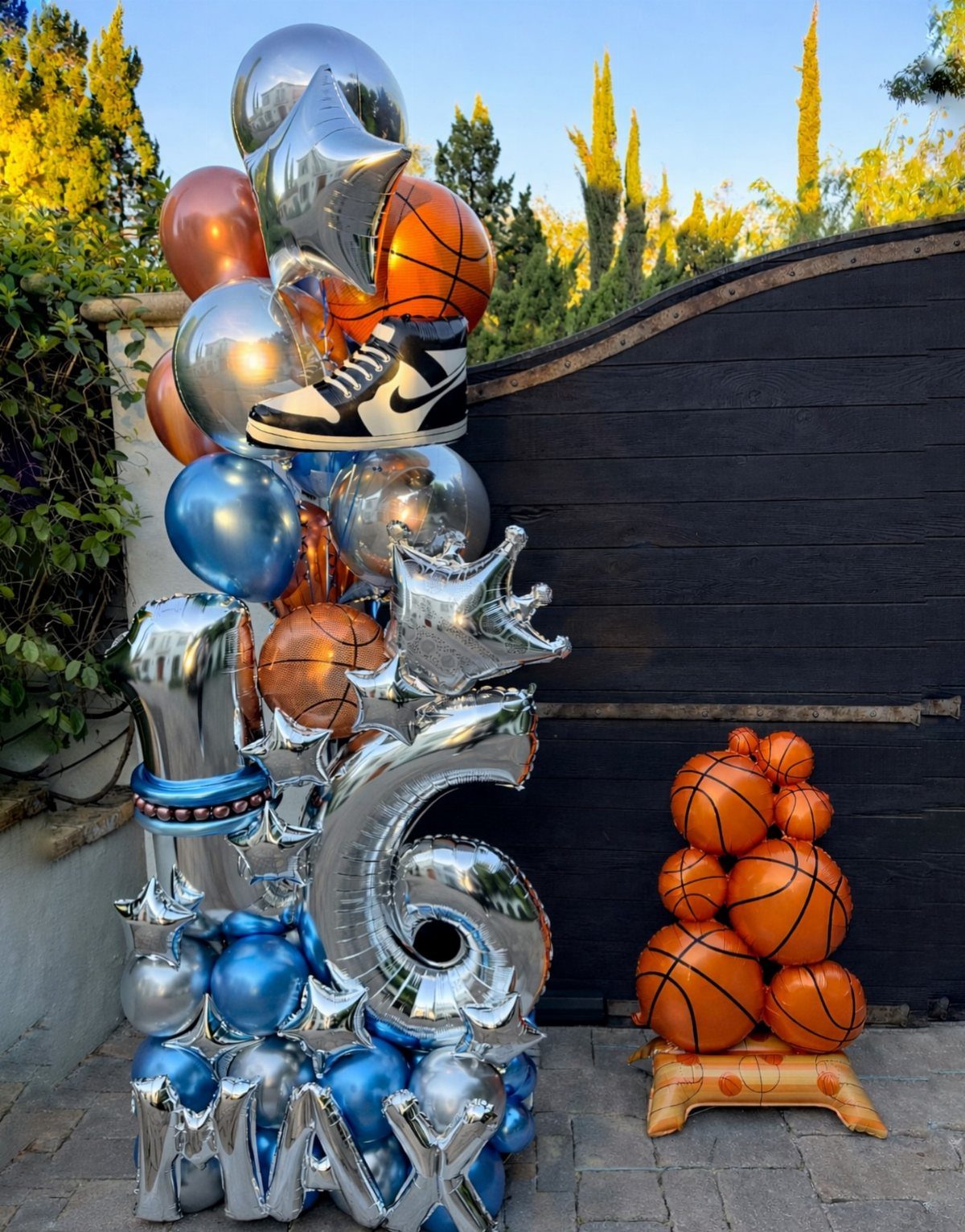 Basketball themed balloon arrangement with number 16 and a stack of basketballs.