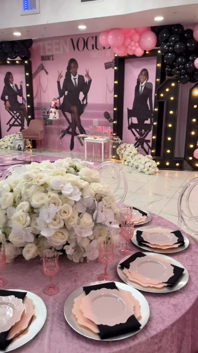 Party table with white roses and pink linens before a Teen Vogue backdrop.