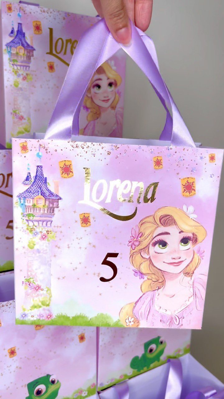 Purple Rapunzel themed party favor bag with a satin handle and personalized text.