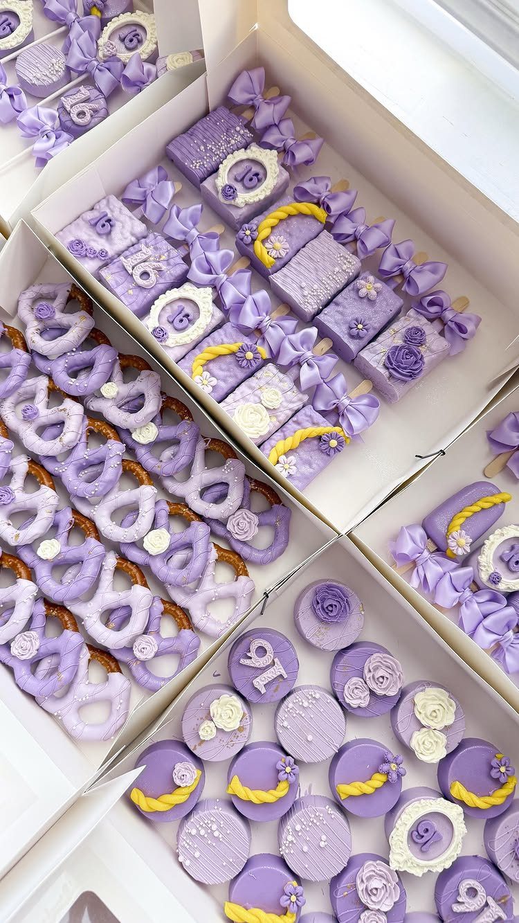 Purple themed desserts with yellow braid decorations in white cardboard boxes.
