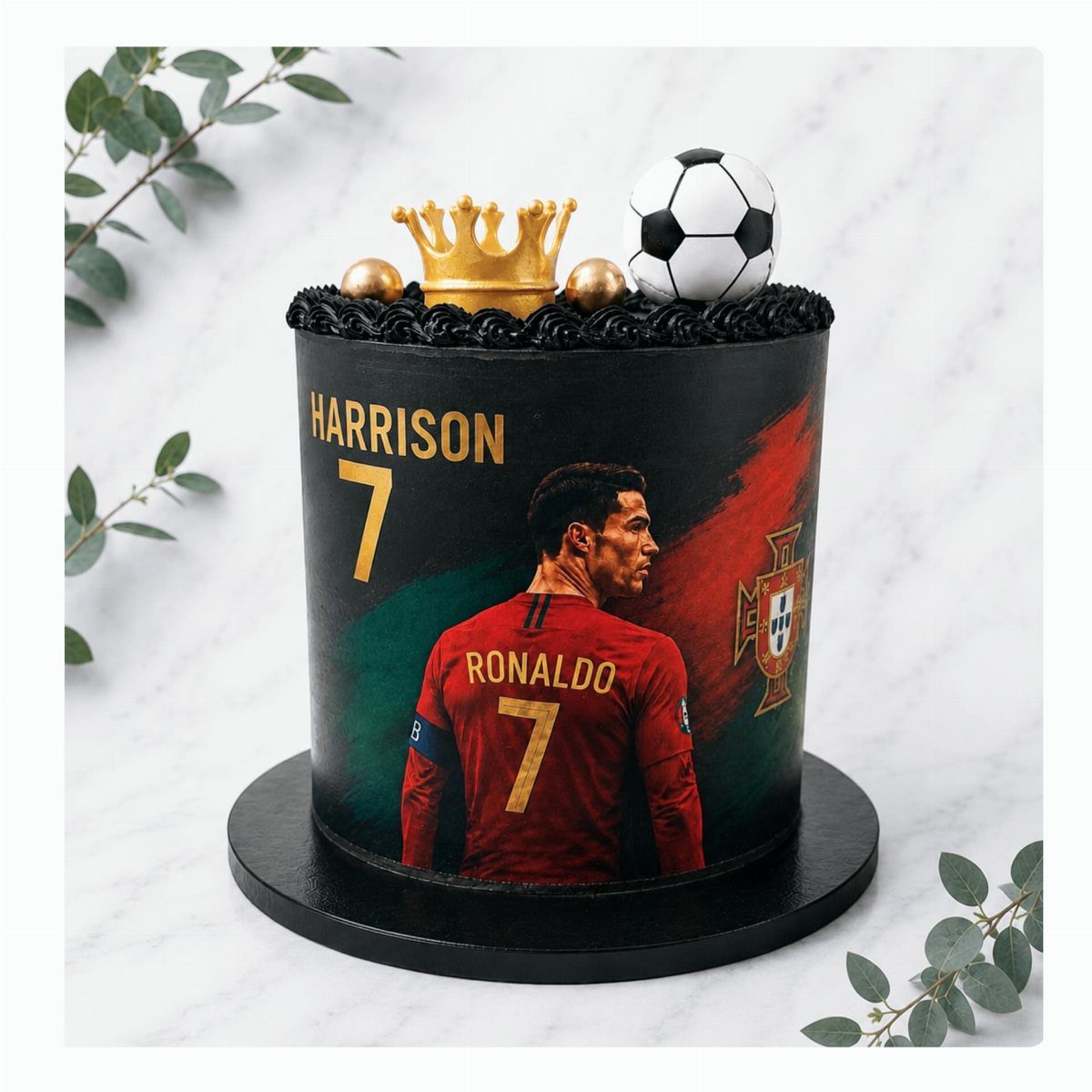 Black birthday cake featuring Cristiano Ronaldo, a soccer ball, and a gold crown.