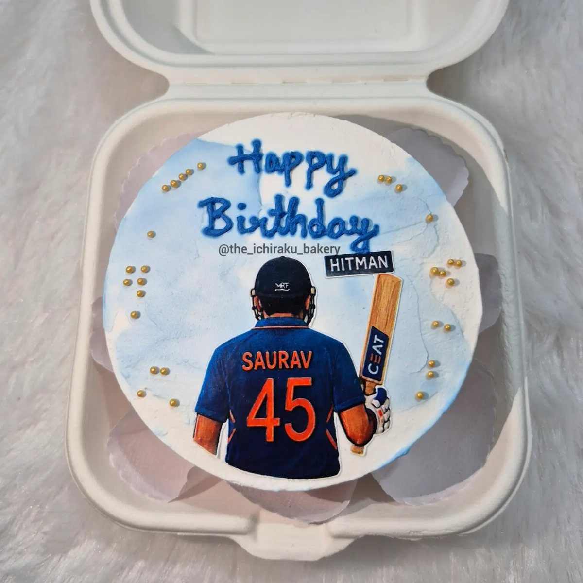 Cricket themed birthday cake featuring a player in a blue jersey and bat.
