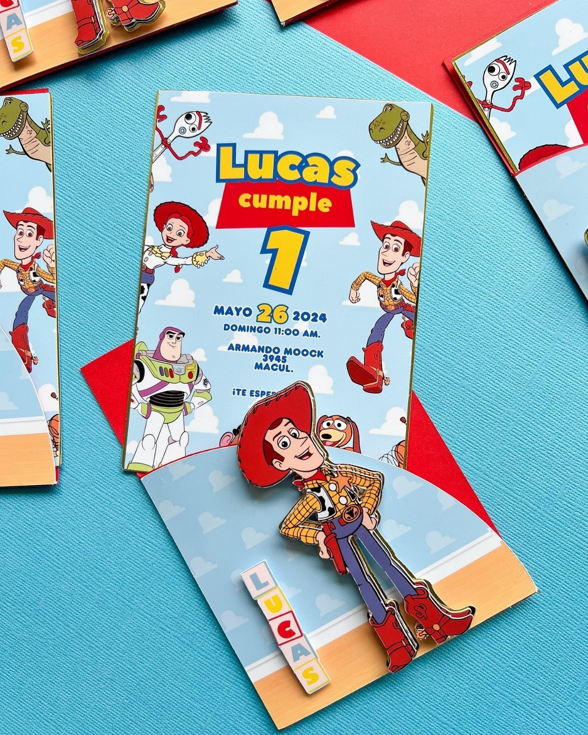 Toy Story themed birthday invitations with Woody and Buzz on a blue background.