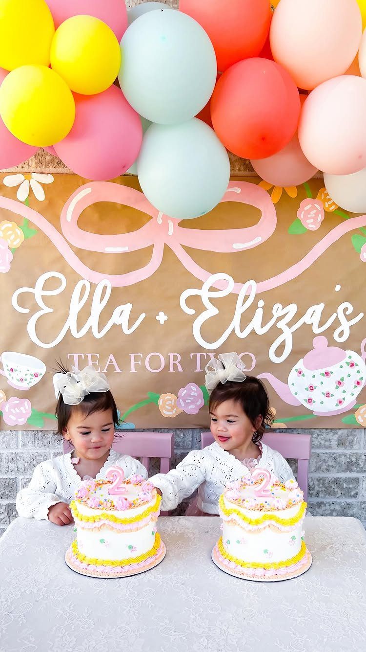 Two toddler girls celebrating their second birthday with a tea party theme.